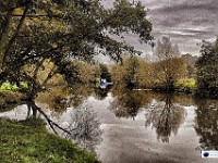 Blue Boat Coming  A November shot, near Wateringbury. The river was flat calm. I had set up what I thought was a lovely panoramic shot. Then a pleasure boat appeared round the bend and I had to rush everything before it spoiled the stillness of the water. I think it actually ended up adding something to the photo! £180
